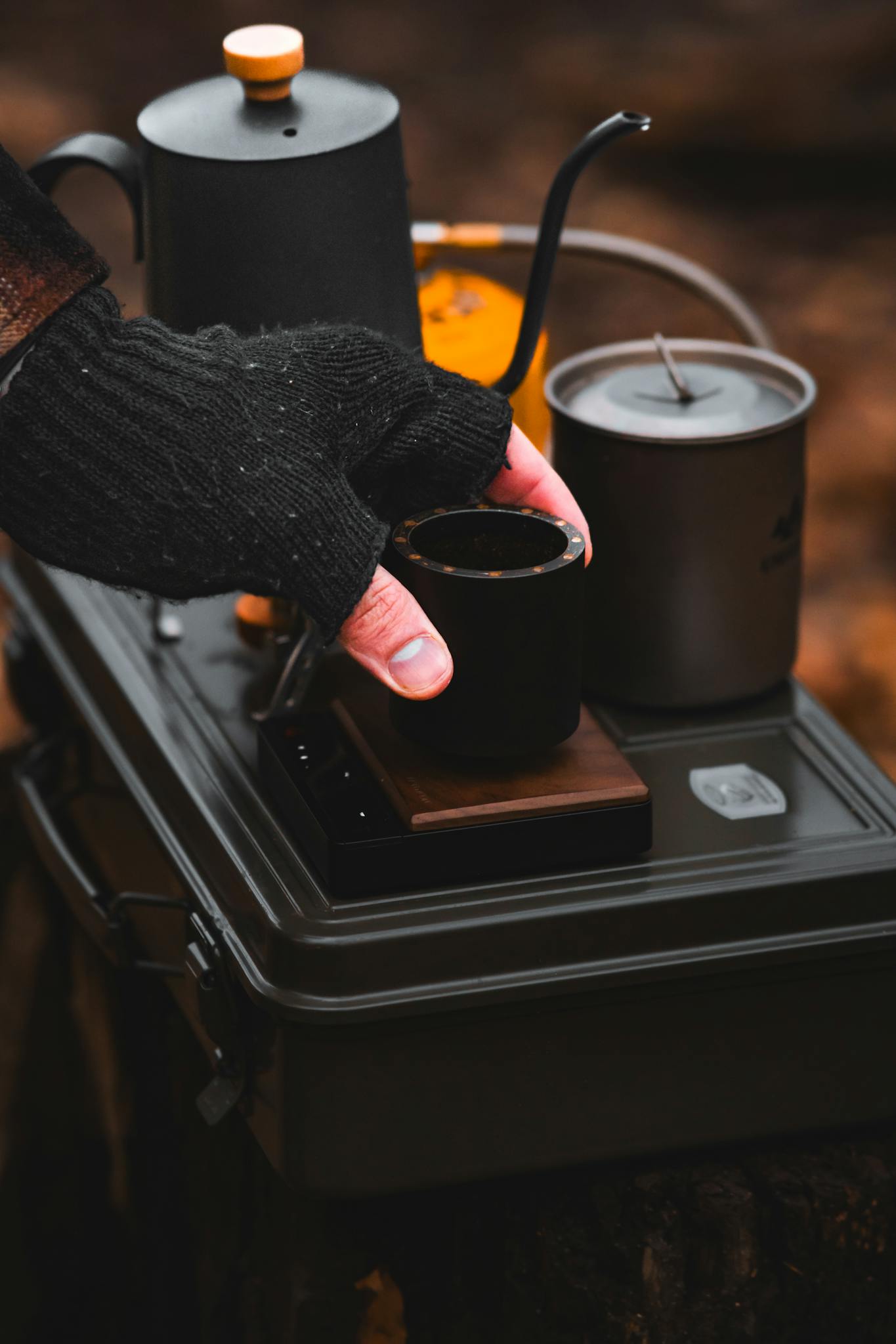 Warm autumn scene with tea setup in a serene forest setting, highlighting the season's coziness.